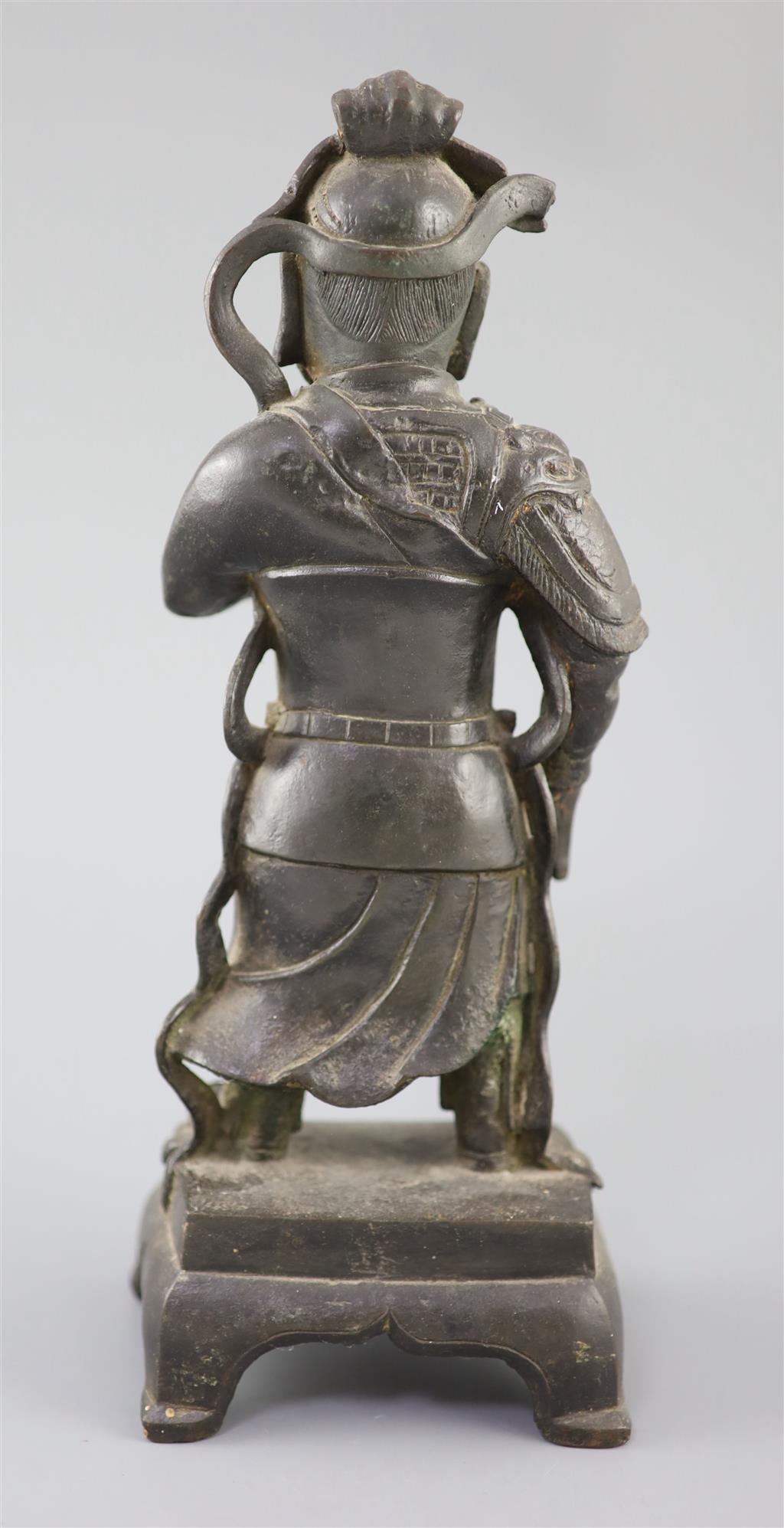 A Chinese bronze standing figure of Guandi, 16th/17th century, 31cm high, small losses